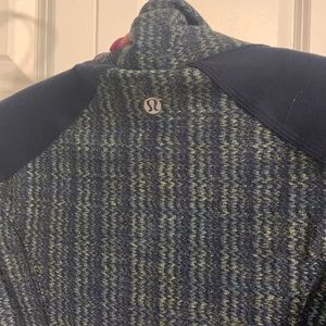 LULULEMON navy blue and green fitted zip up. Has original elastic on zipper.
